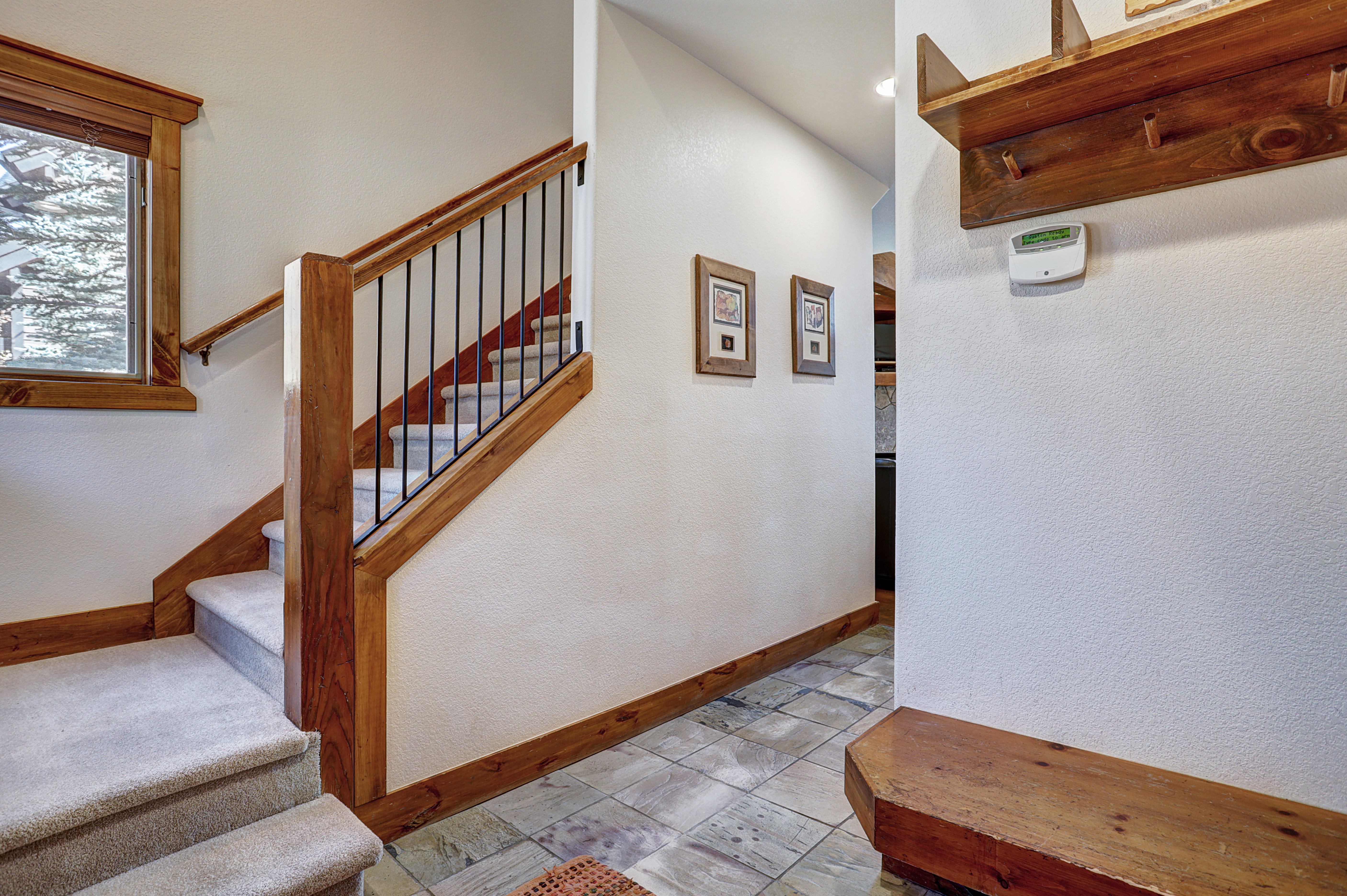 Store your shoes and winter gear in the entryway coat closet and bench storage - Amber Sky Breckenridge Vacation Rental