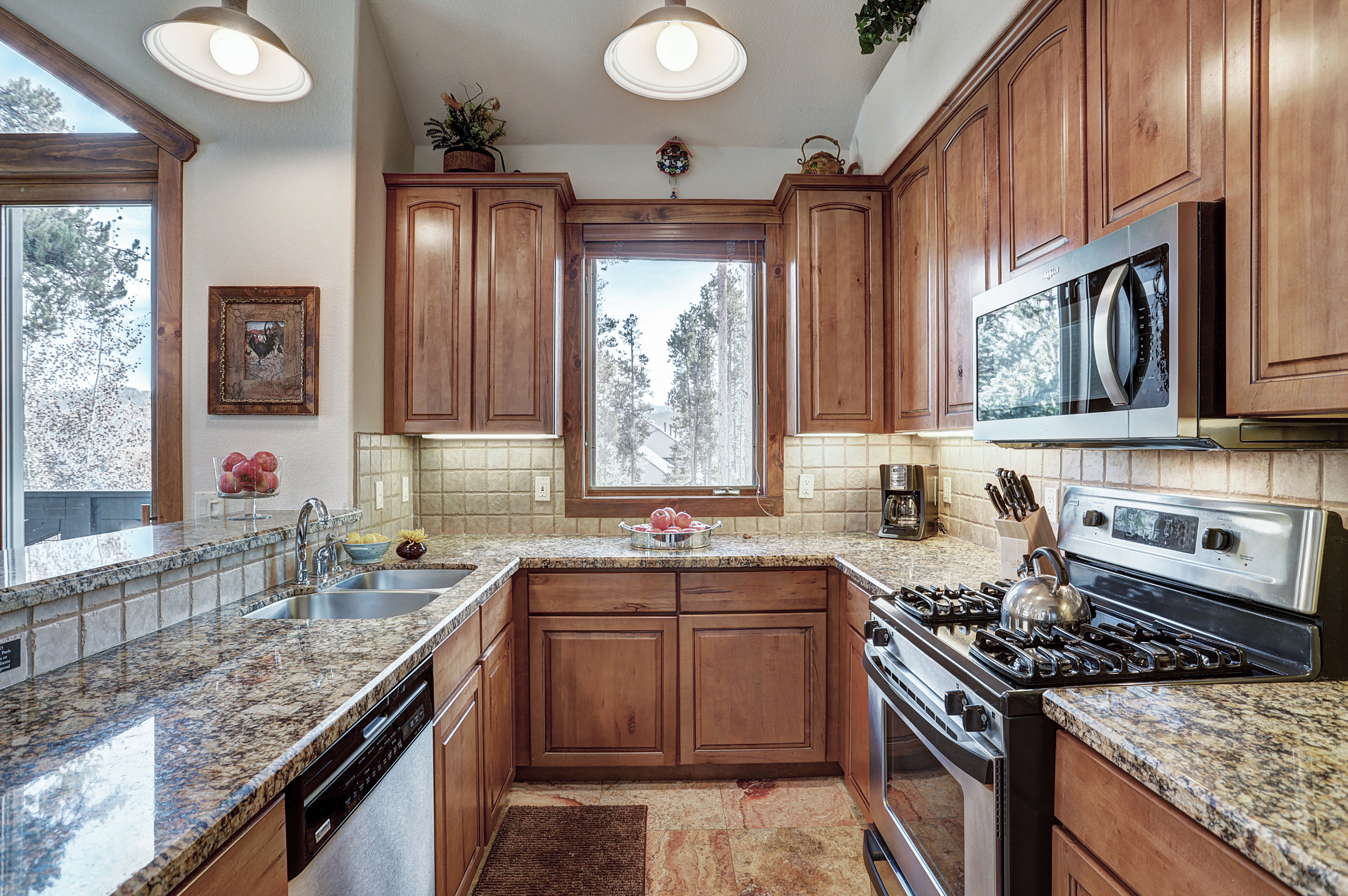 This spacious kitchen boasts updated stainless steel appliances and granite countertops - Amber Sky Breckenridge Vacation Rental