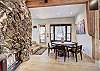 Dining table with seating for 6 situated beside the gas fireplace - Arrow Darrow Breckenridge Vacation Rental 