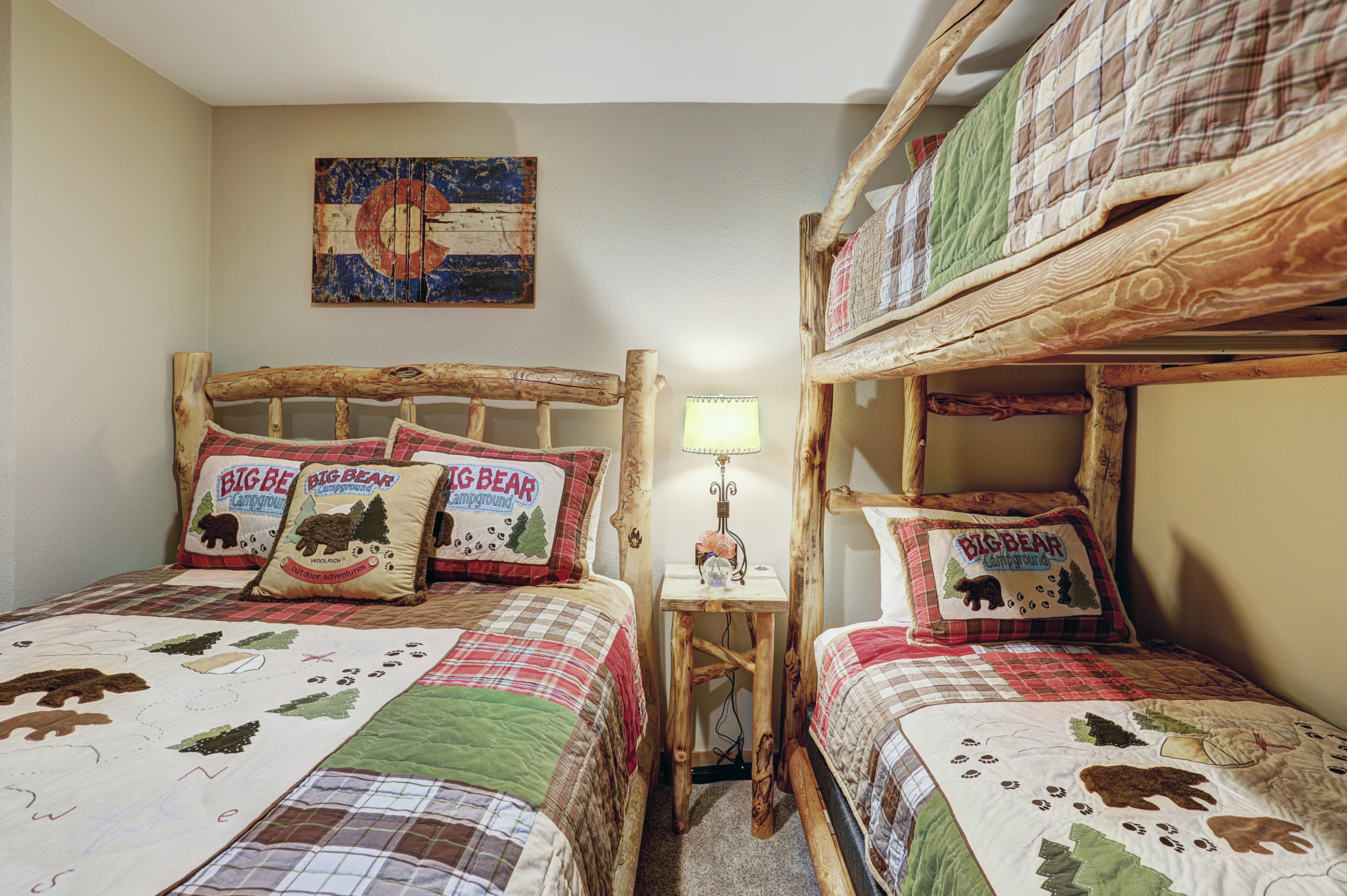 Main level bedroom with Queen-size bed and Twin over Twin bunks & shared bath - Atrium 108 Breckenridge Vacation Rental
