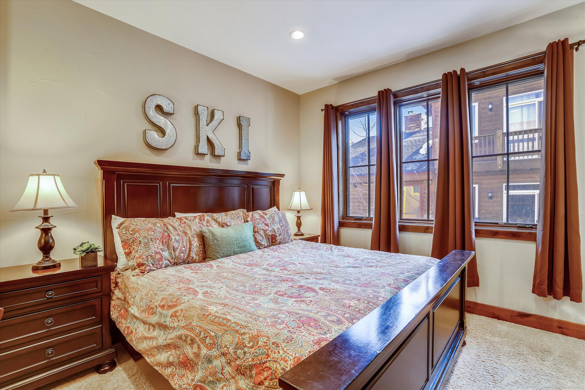 Upper level bedroom with King-size bed, desk, and private bath