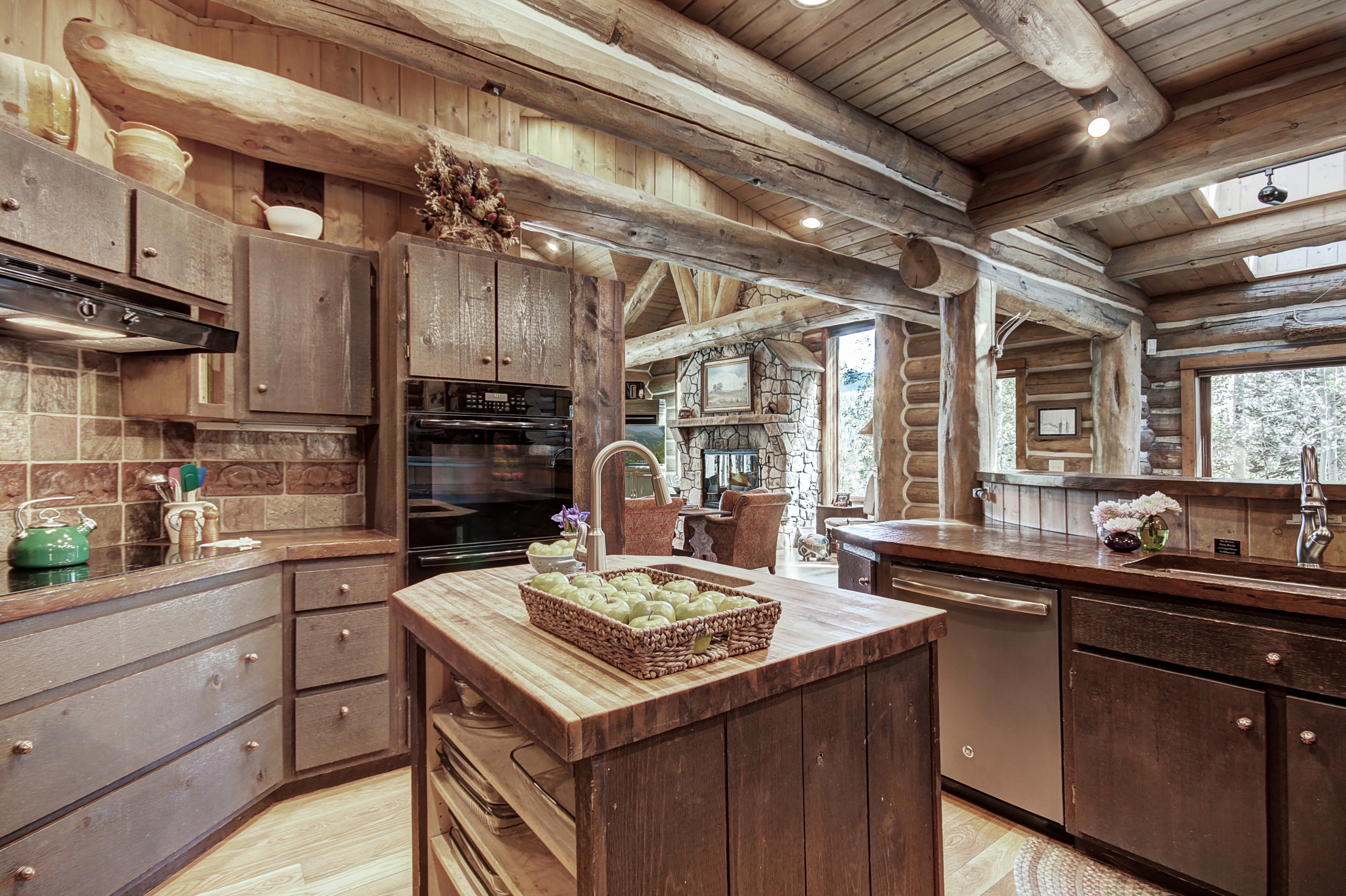 The island in the center of the kitchen offers a butcherblock counter - Bear Lodge Breckenridge Vacation Rental