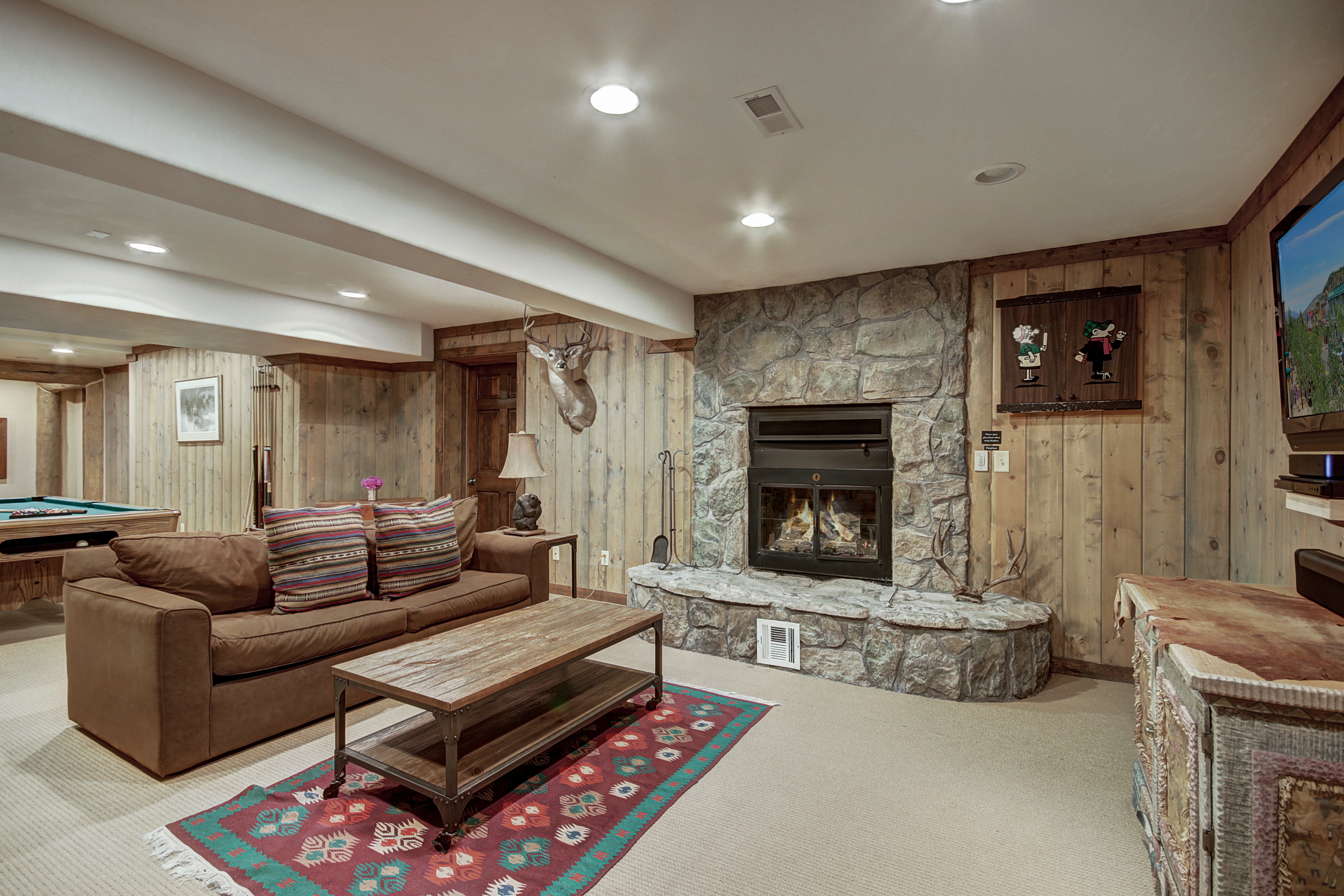 Bottom floor family/game room offers flat screen TV, gas fireplace, and a pool table - Bear Lodge Breckenridge Vacation Rental