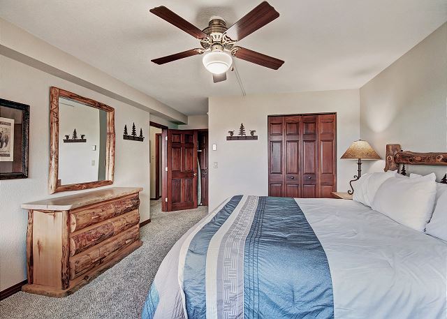 This bedroom offers a spacious area with cozy amenities. - Beaver Run Black Diamond Penthouse Breckenridge Vacation Rental