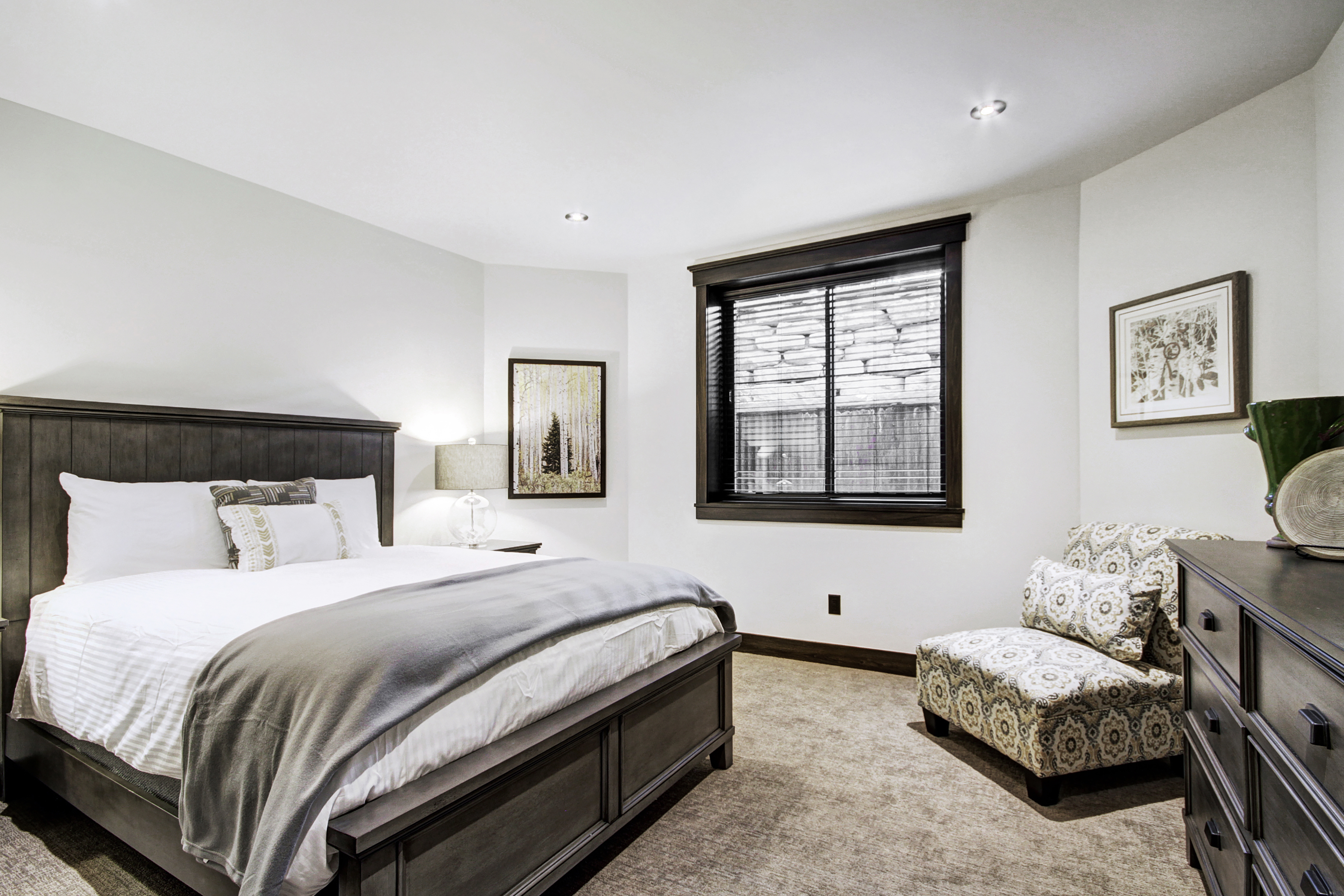 Lower level queen bedroom with flat screen TV and en-suite bathroom. -  The Bogart House Breckenridge Vacation Rental