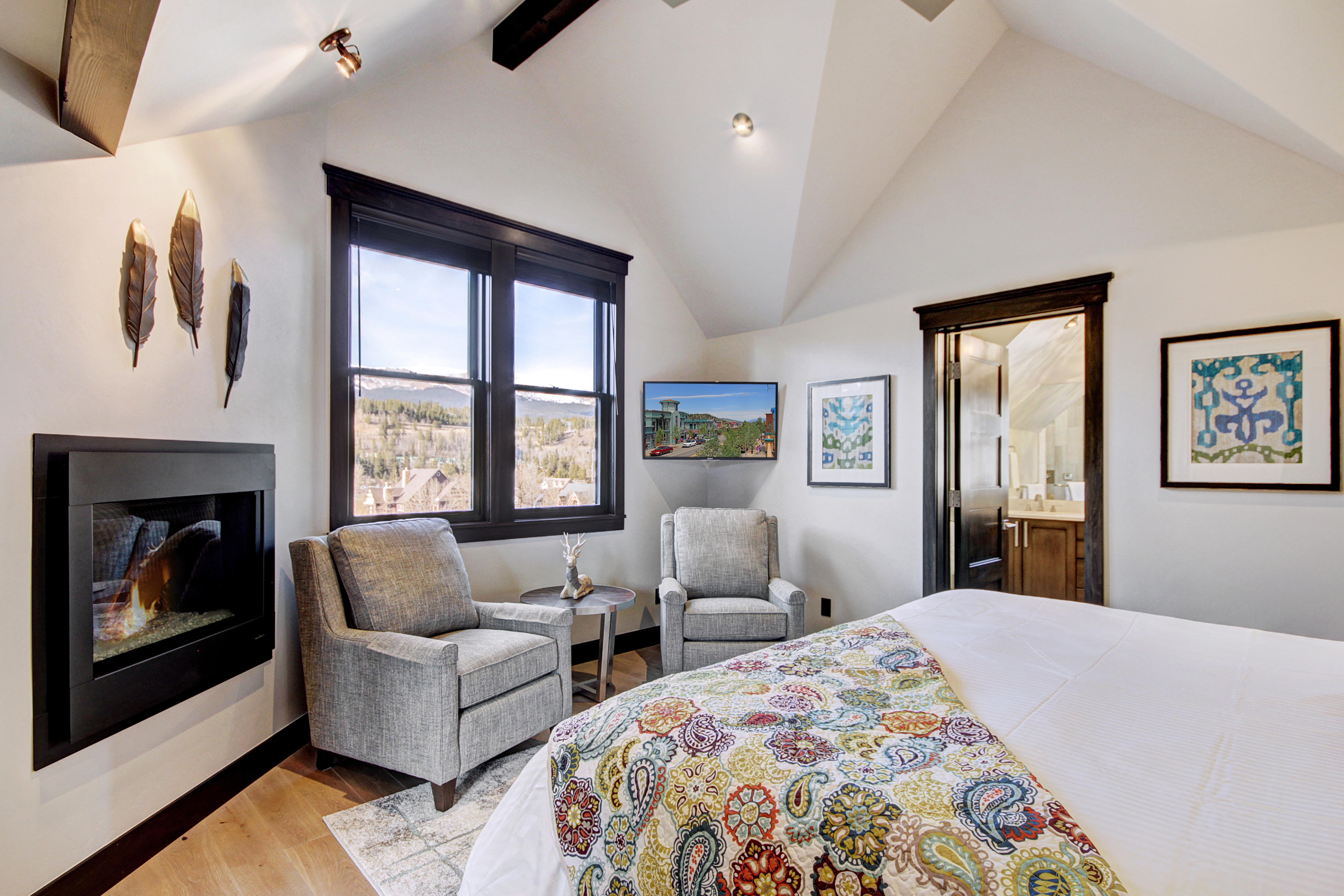 The upper level master suite offers a king bed, gas fireplace and flat screen TV -  The Bogart House Breckenridge Vacation Rental