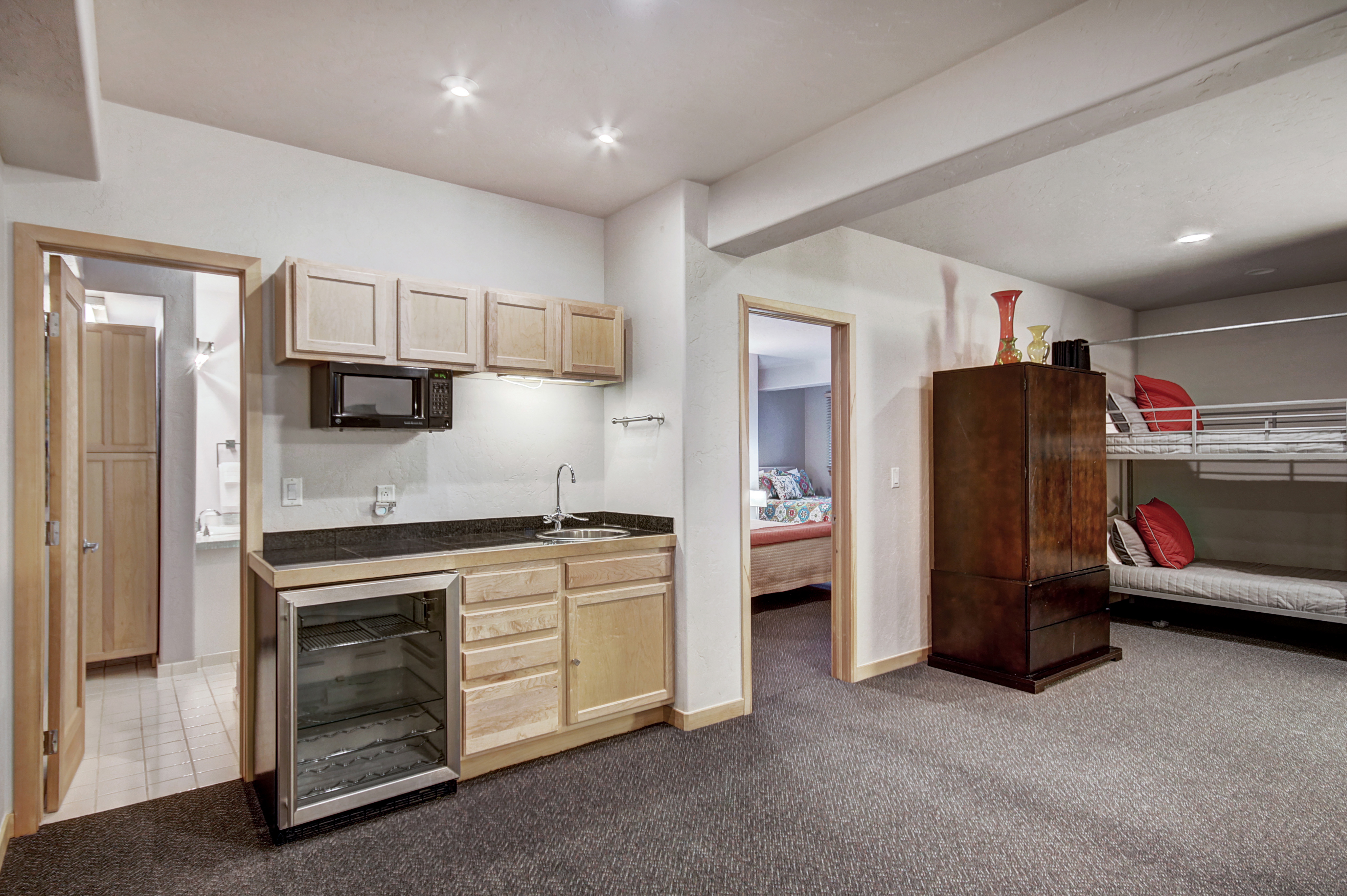 Kitchenette equipped with mini-fridge, stove/oven, microwave, sink, and wine fridge. - Buffalo Mountain Vista Frisco Vacation Rental