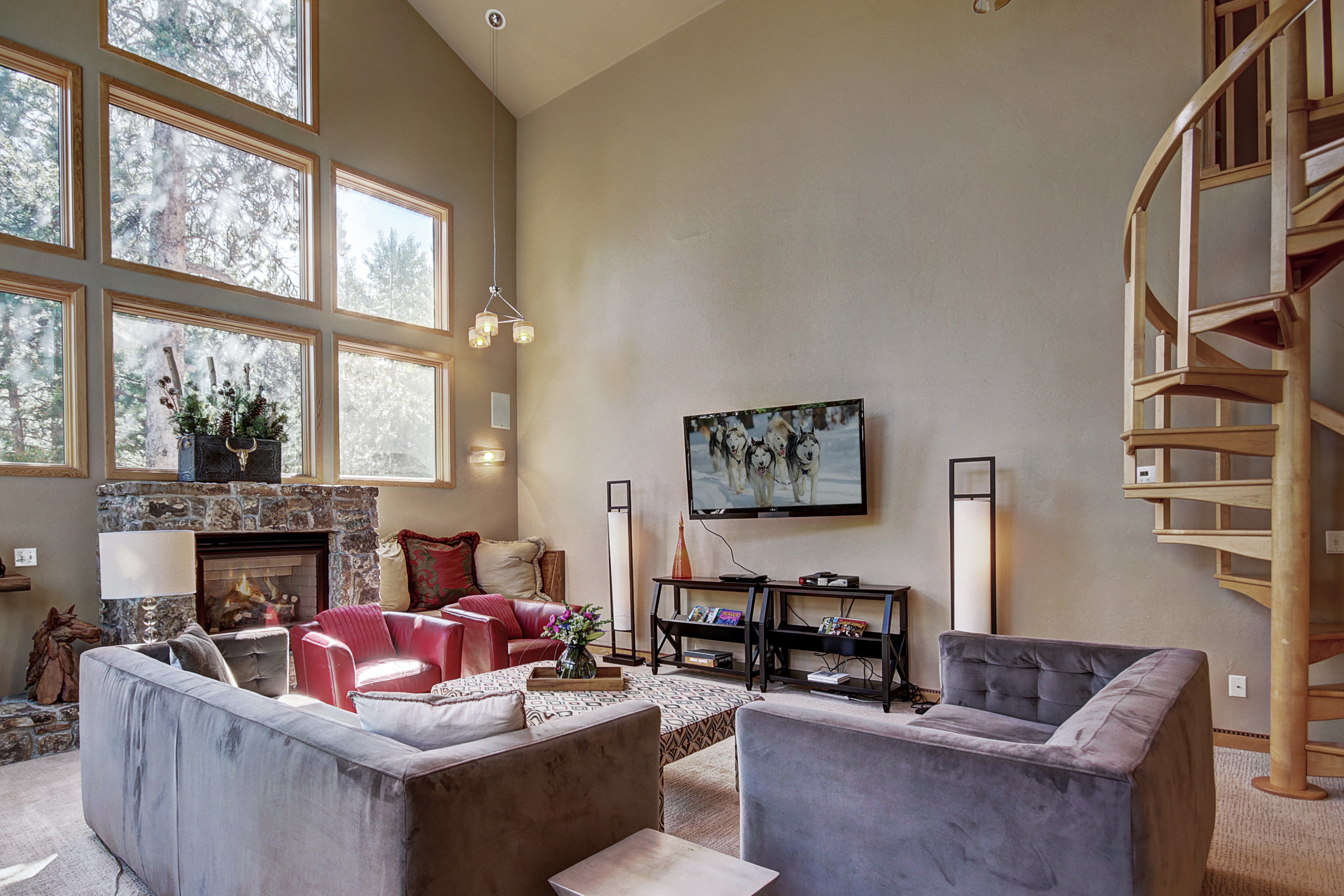 Relax in the large living room with a gas fireplace and flat screen TV. - Buffalo Mountain Vista Frisco Vacation Rental
