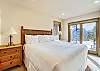 Lower level king bedroom with flat screen TV and deck access. - Charter Ridge 10 Breckenridge Vacation Rental 