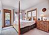 Queen bed in lower level bedroom with access to patio/hot tub and shared bath. - Charter Ridge 60 Breckenridge Vacation Rental 