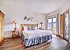 Master bedroom with King-sized bed on mid-level with private deck. - Charter Ridge 60 Breckenridge Vacation Rental 