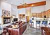 View of spacious living room and dine-in kitchen from back doors. - Charter Ridge 60 Breckenridge Vacation Rental 