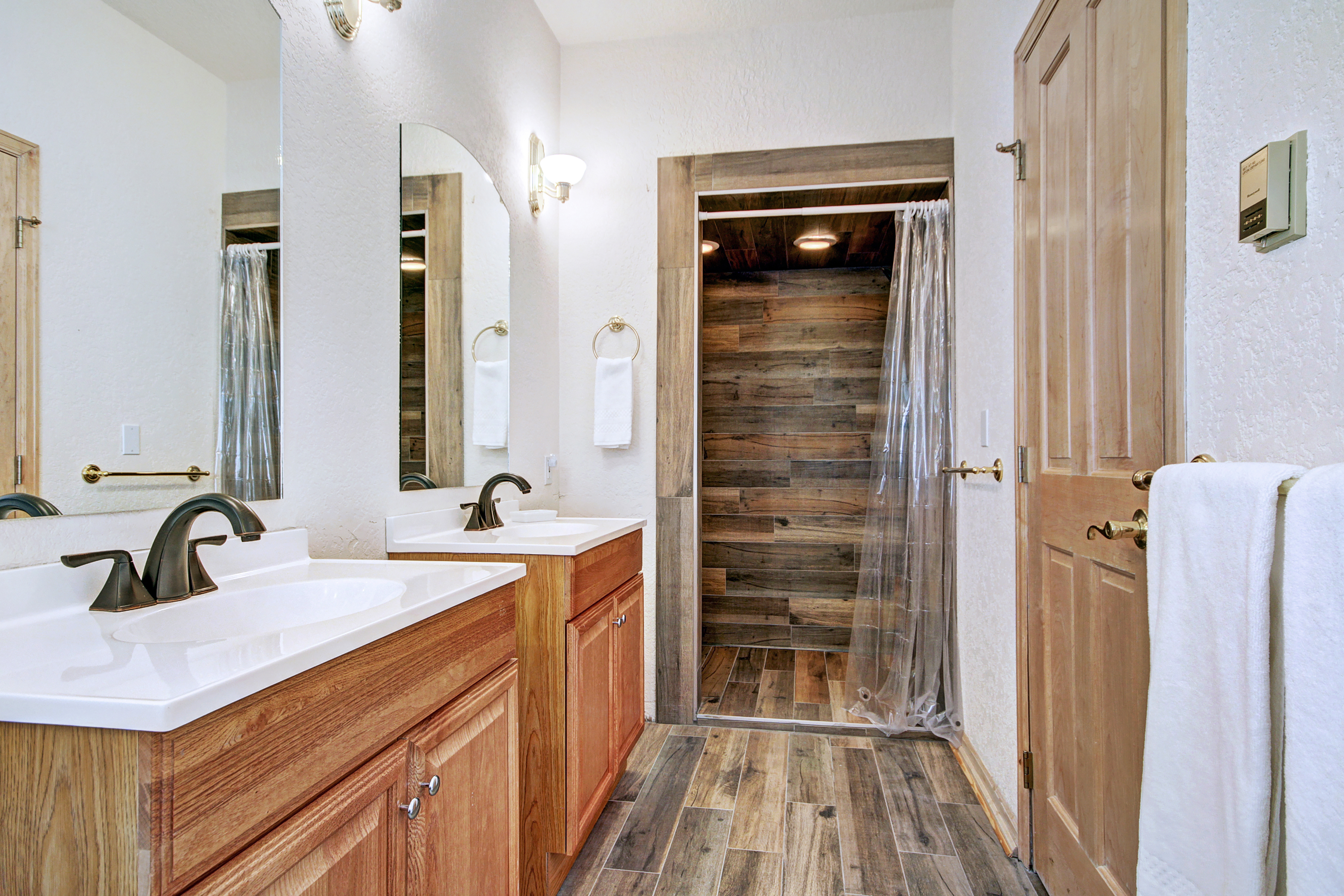 Mid-level master private bath with walk-in shower and 2 sinks.