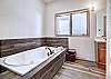 Master private bath with large jetted bathtub for soothing sore muscles. - Charter Ridge 60 Breckenridge Vacation Rental 