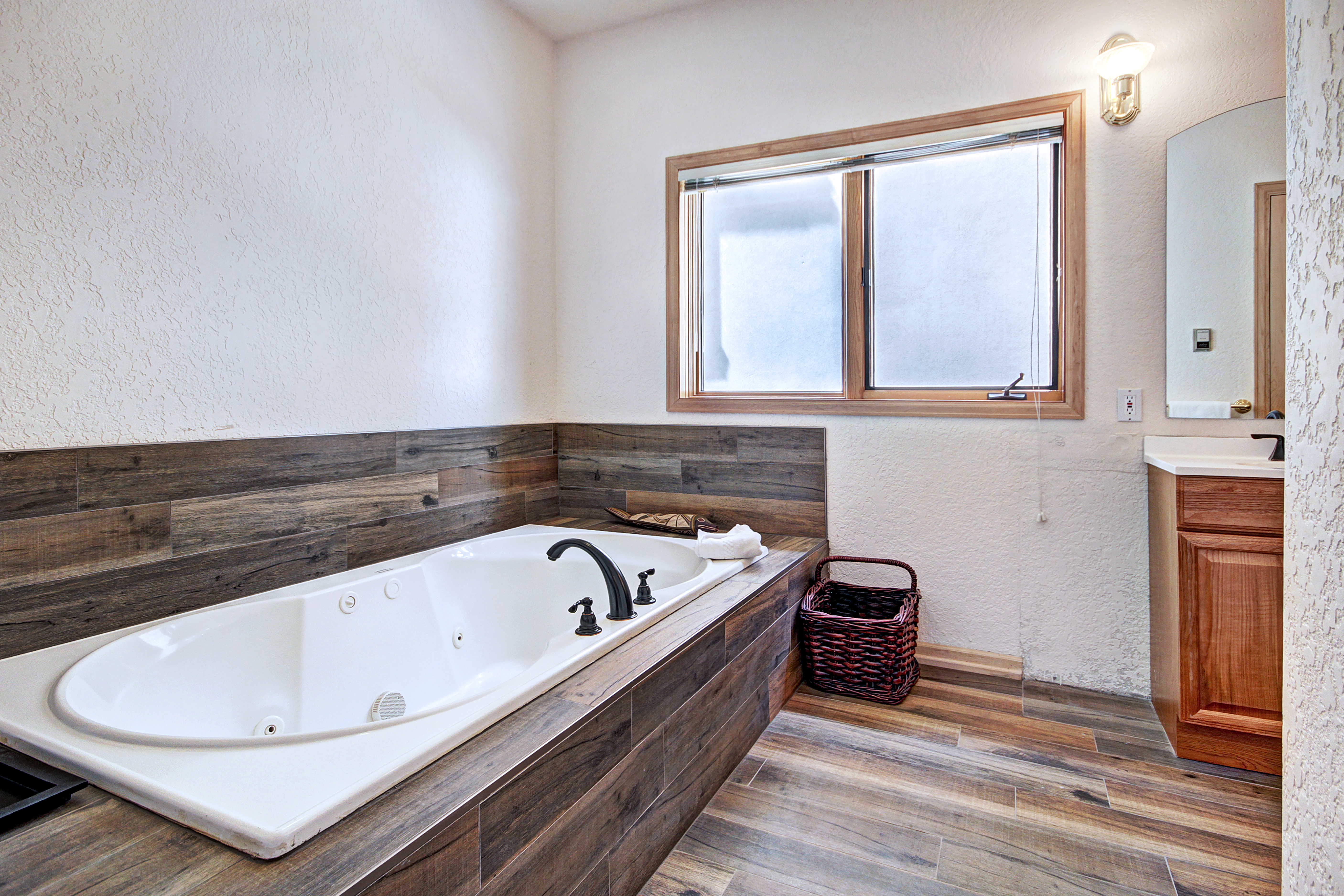 Master private bath with large jetted bathtub for soothing sore muscles.