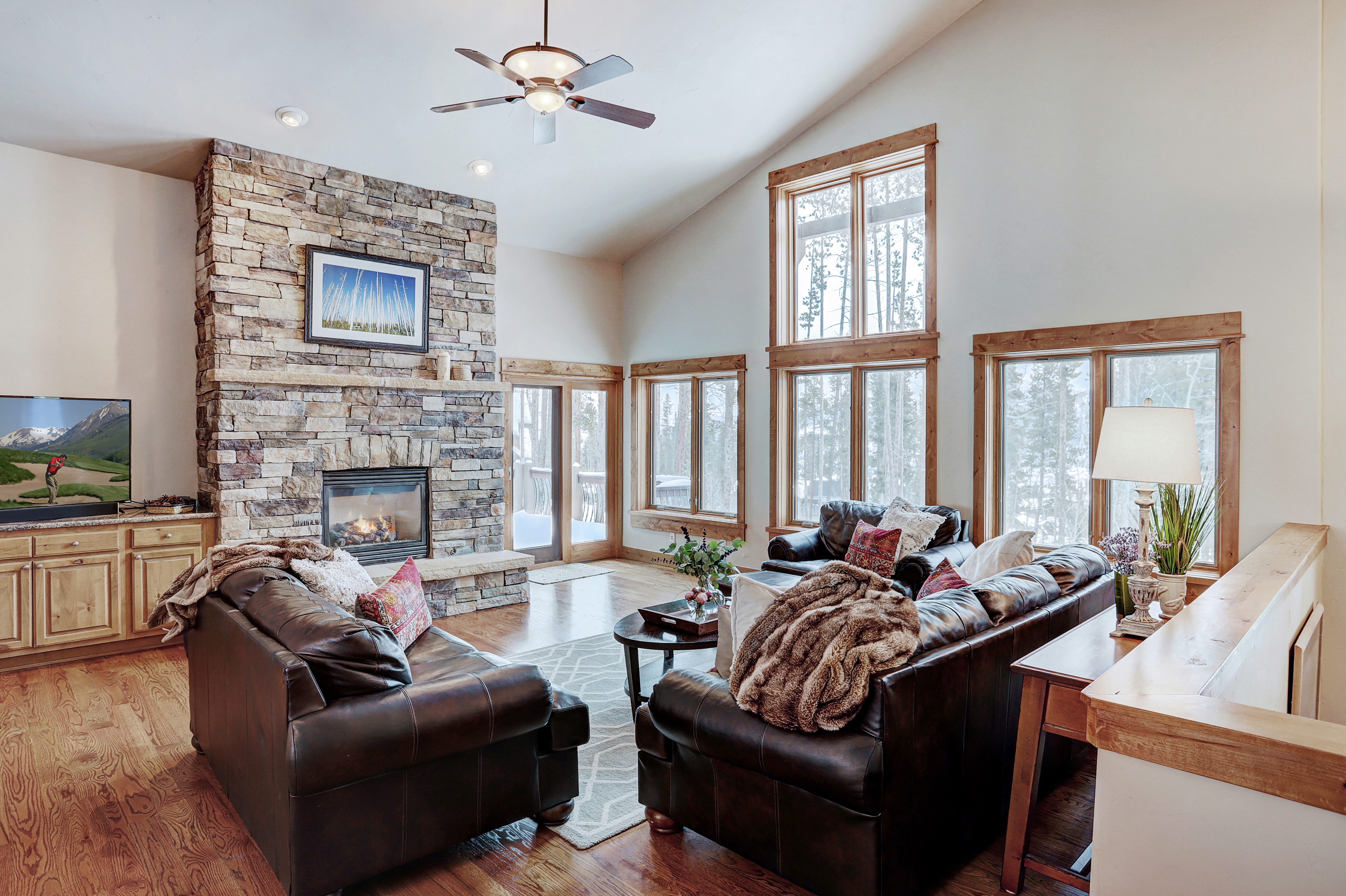 Living area with gas fireplace and flat-screen TV - Highlands Trail House Breckenridge Vacation Rental