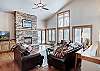 Living area with gas fireplace and flat-screen TV - Highlands Trail House Breckenridge Vacation Rental