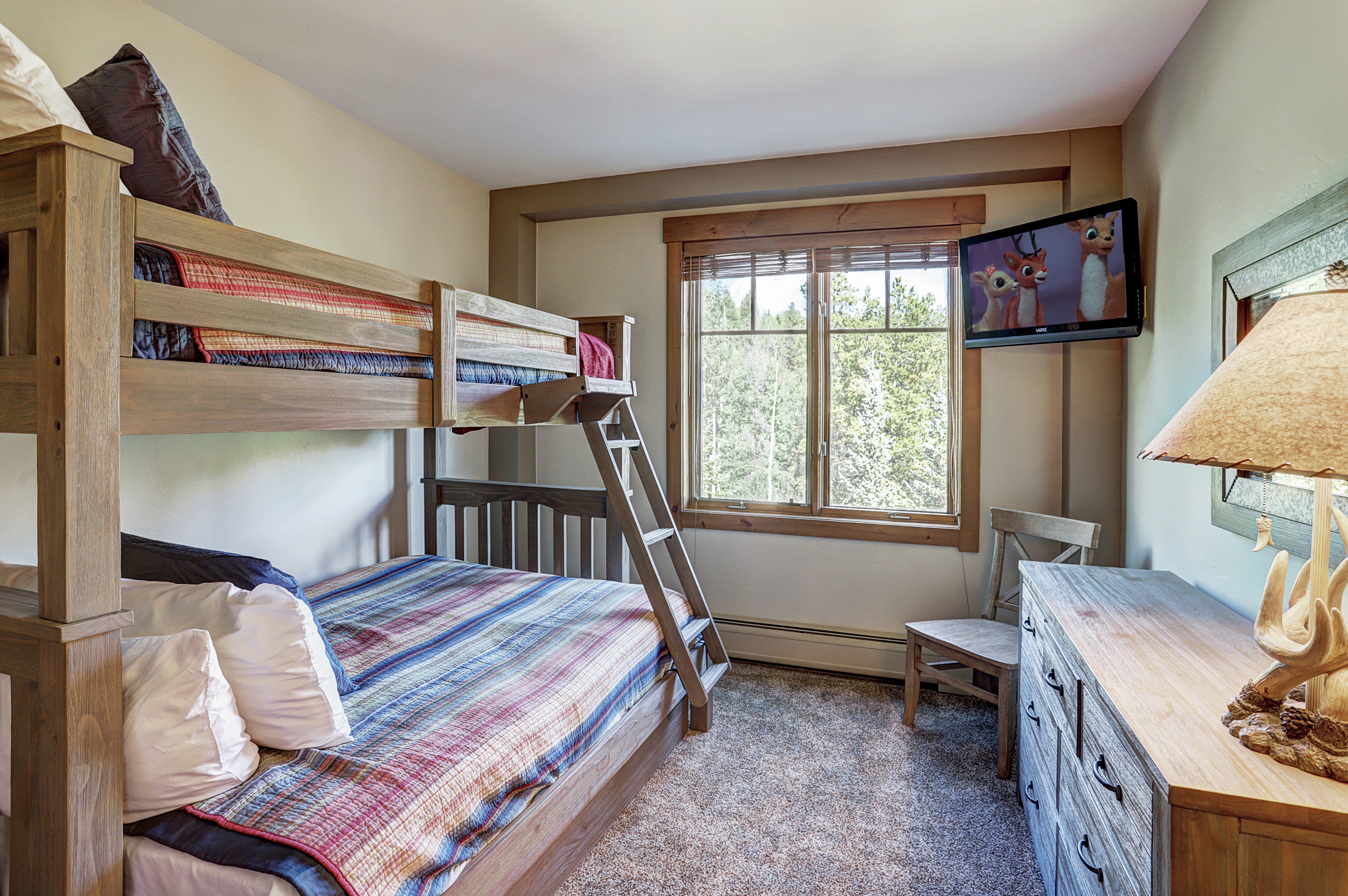 Second bedroom with Twin over Full bunk beds, flat screen TV, and shared bath