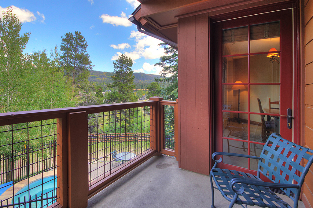 Balcony view of mountains and community hot tub (one of many hot tubs on site)