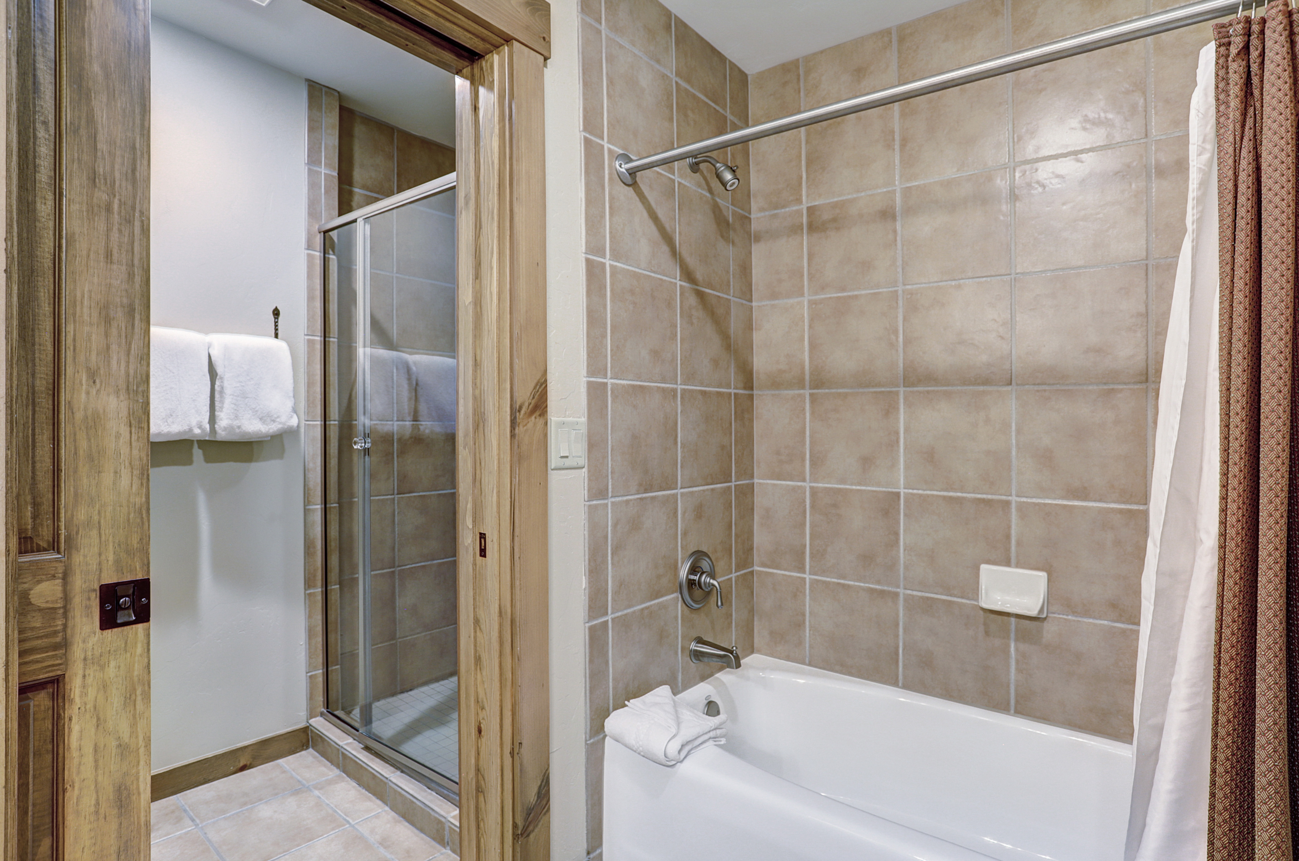 Master bathroom includes both a walk-in shower and combination bathtub/shower