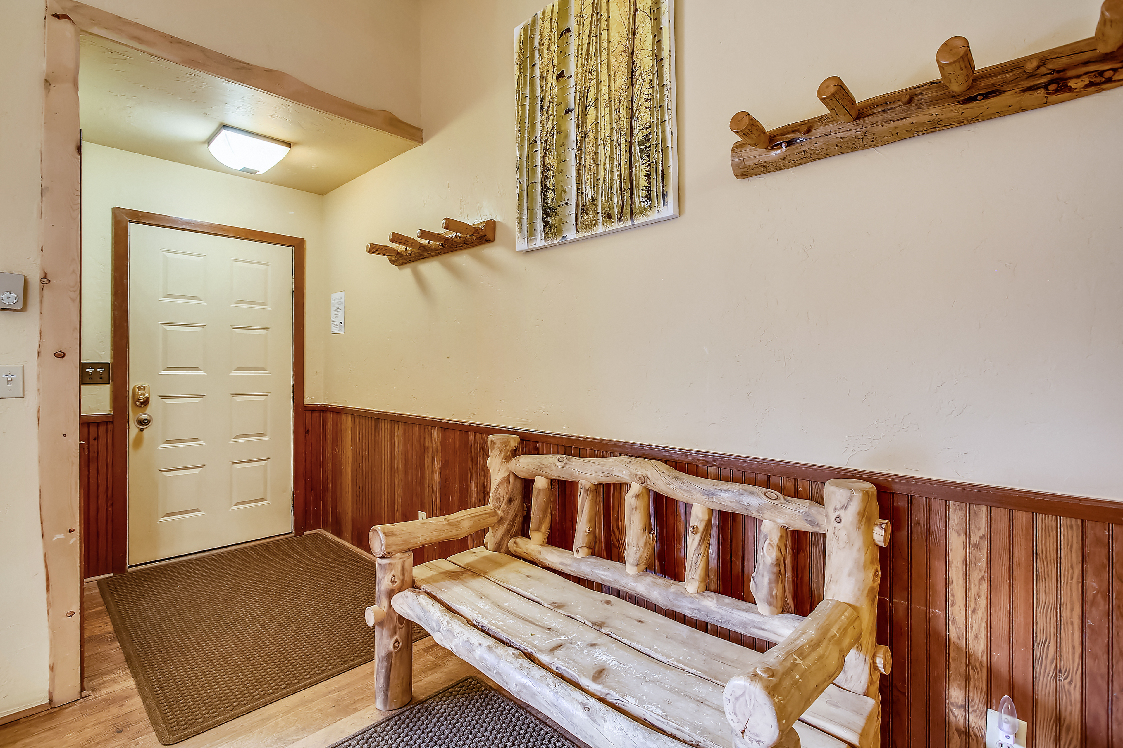 Entryway area with coat hooks and bench - Cedars 53 Breckenridge Vacation Rental
