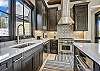 This astonishing kitchen boasts stainless steel appliances - Barton Creek Vista Breckenridge Vacation Rental 