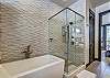 View of the bath tub and walk in shower in the master bathroom - Barton Creek Vista Breckenridge Vacation Rental 