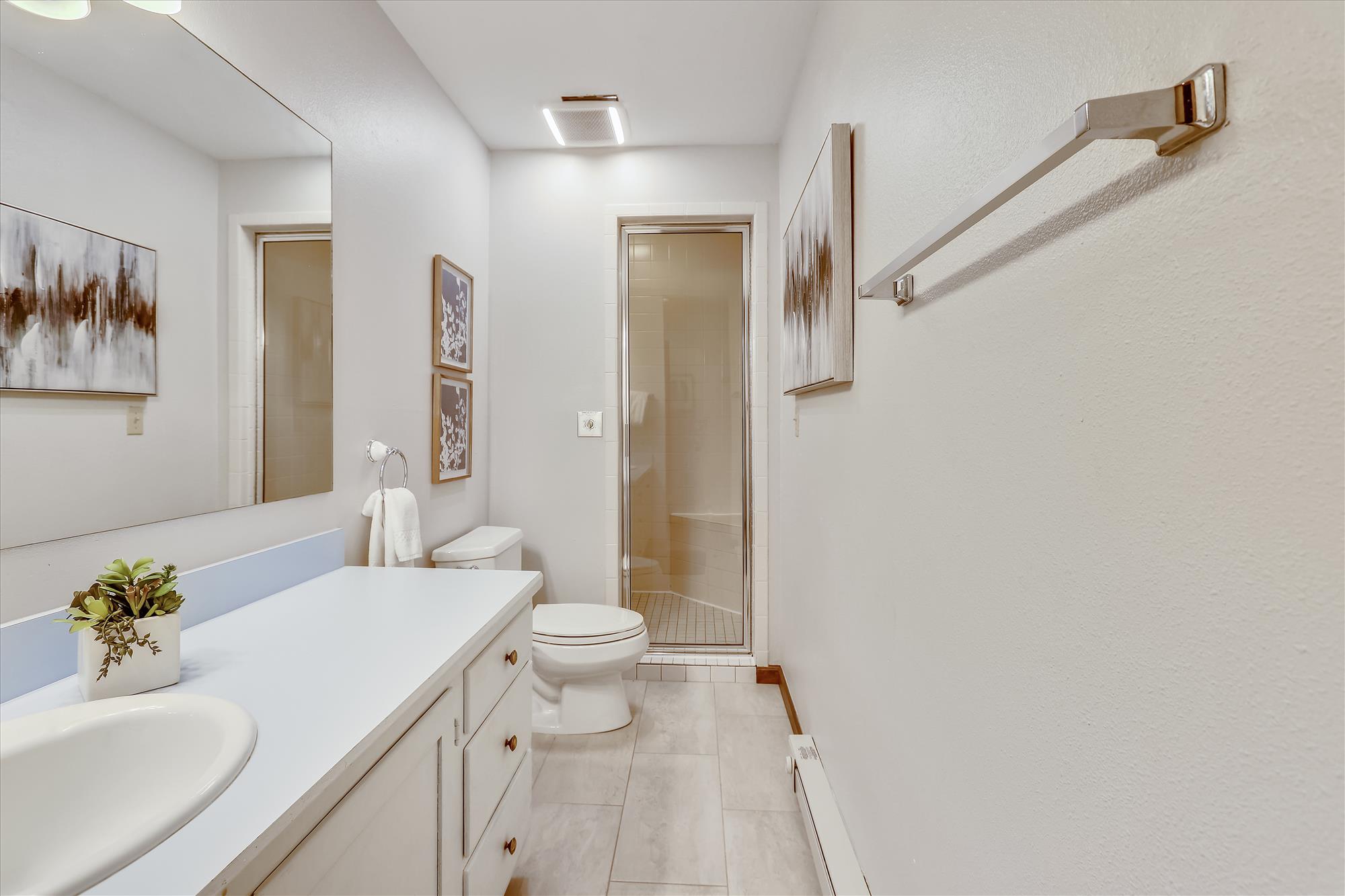 Bottom floor shared bathroom with walk in shower and large vanity - Calderon De La Breck Breckenridge Vacation Rental