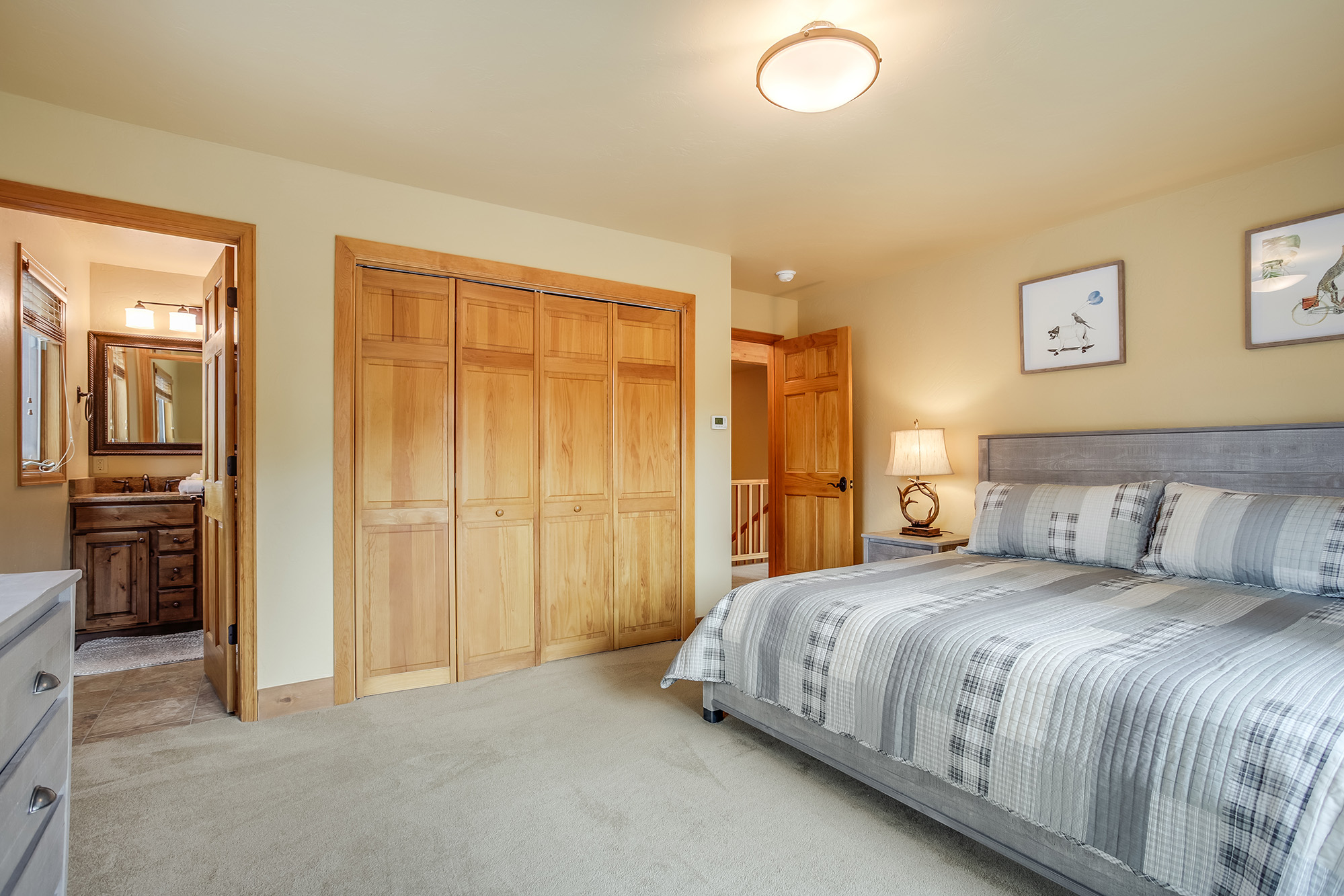 King bedroom with view of private bathroom - Friendly Fox Chalet - Breckenridge vacation rental