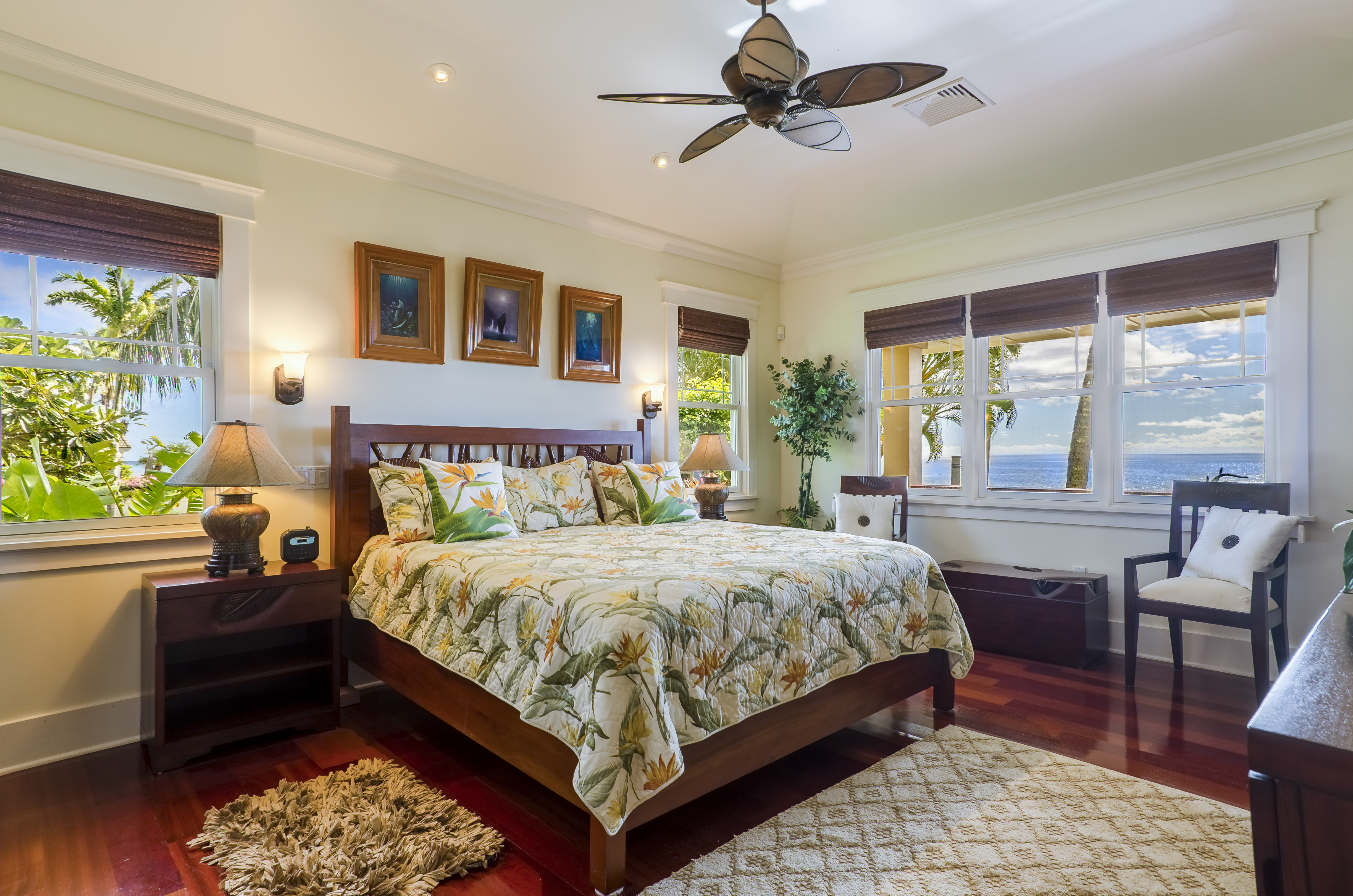 The master bedroom has a comfortable king bed, luxury furnishings and linens, and views of the Pacific waves.