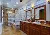 Master bedroom ensuite bath is has double sinks and mirrors, a jacuzzi tub and granite shower.
