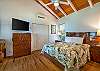 Koa Cottage's master bedroom features ocean views from a king bed and opens via double doors to the front lanai.