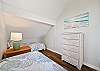 The third bedroom features two twin beds and hardwood floors, id