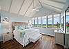 Master bedroom features a king sized bed with luxury linens