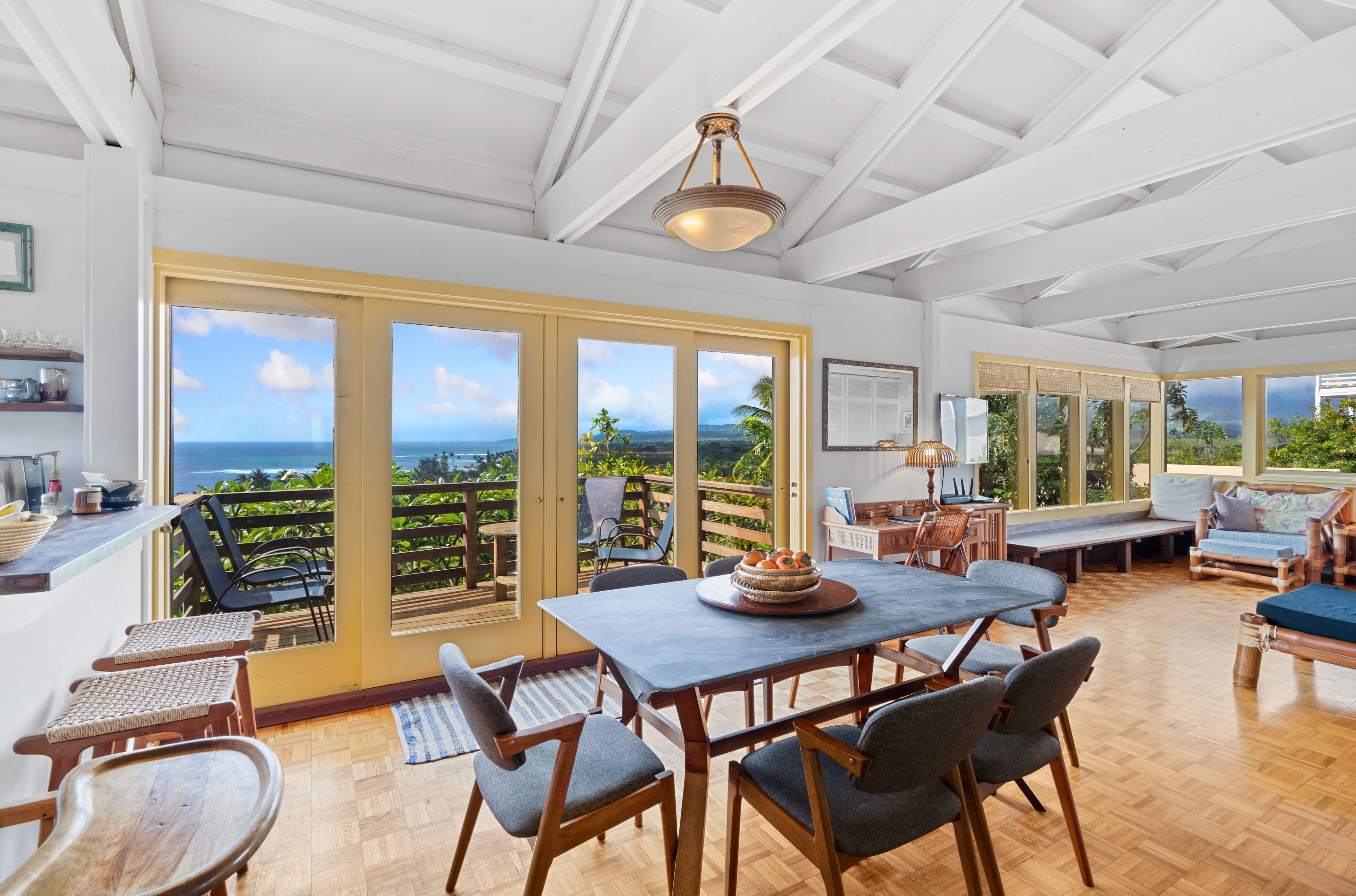 Amazing views of two Poipu beaches and surf spots, the Poipu coastline, Ni'ihau island, swaying palms, and rugged green mountains and waterfalls from the living area located on the second floor.