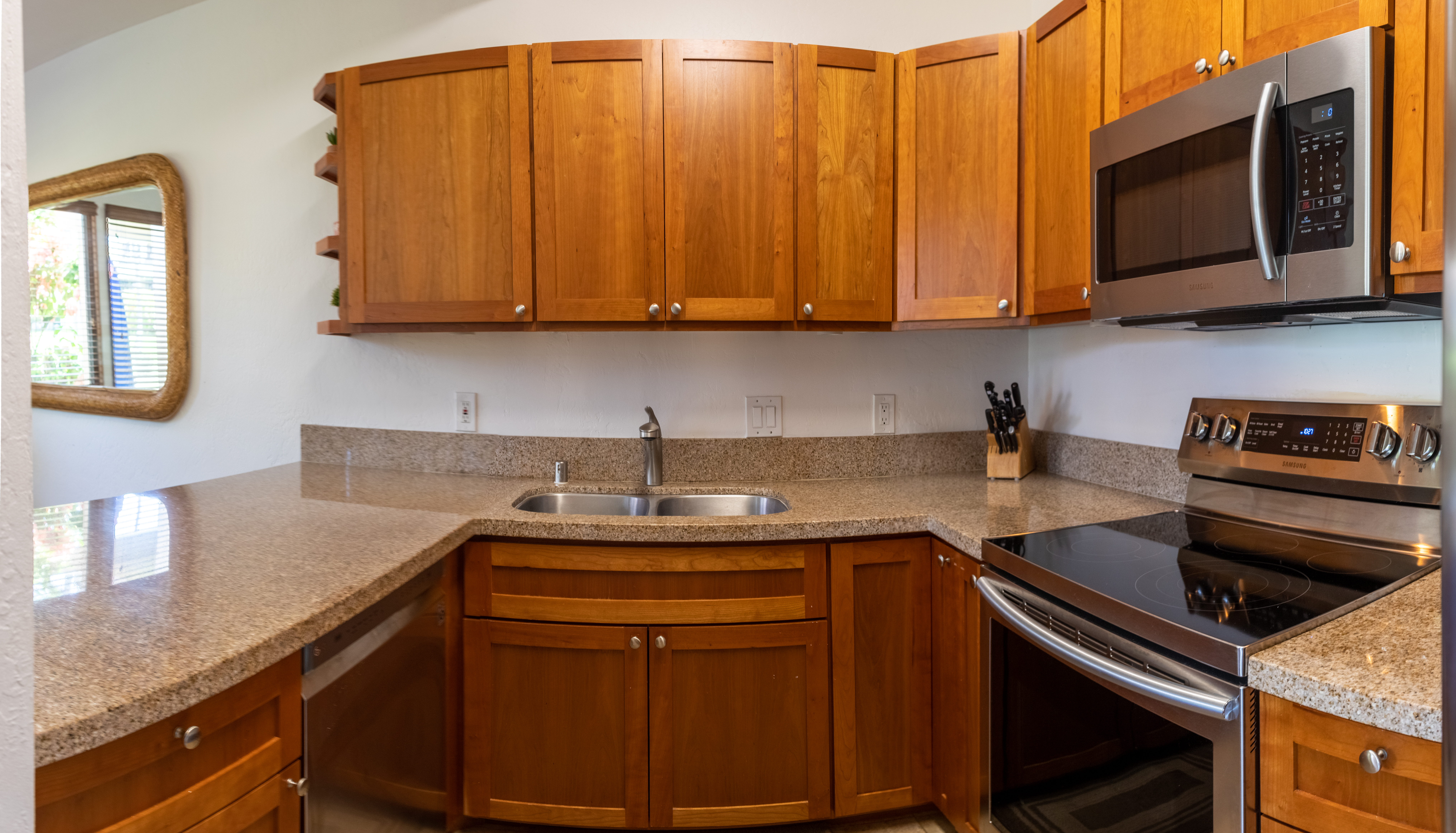 Full kitchen with oven and glass electric cooktop, microwave, double sink, dishwasher and full refrigerator allow you all the comforts of home and plenty of amenities to be able to cook whatever local food you find!