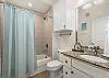 Hall bathroom with shower/tub combo 