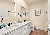 En suite bathroom in the primary with double sink vanity 