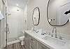 Double sink vanity and walk-in shower. 