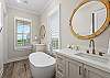 Master bathroom with 2 separate vanities and a soak tub. 