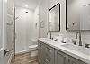 Double sink vanities and walk-in shower. 