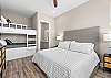 This 4th bedroom is the ultimate family room offering a king bed ajnd 2 sets of full over full custom built in bunk beds in addition to an ensuite bathroom.