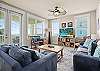 Spacious living room with large windows facing the ocean 