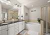 Primary bathroom with a double sink vanity 