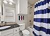 Hallway bathroom with shower/tub combo 