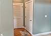 Hallway to garage, utility closet and powder room 