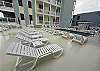 Large pool deck with plenty of lounge chairs to enjoy.