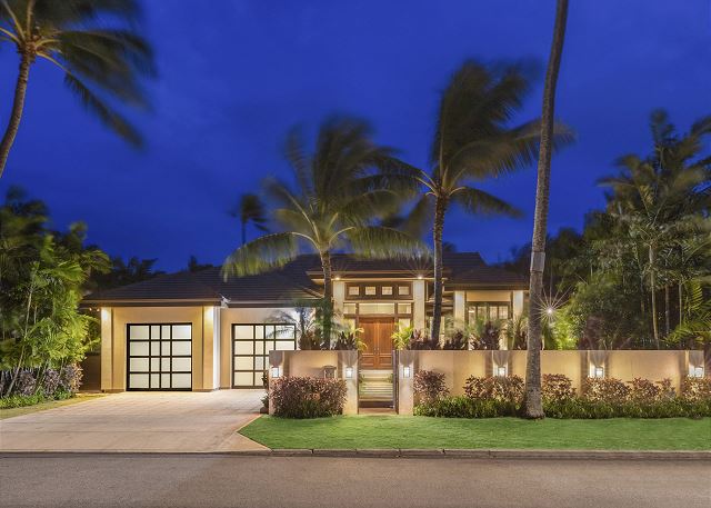 Elegant contemporary design with lush, tropical landscaping throughout the property.
