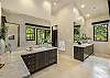 Dual sink/vanities in master bath lead to a tranquil, landscaped garden/lanai