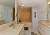 Features dual sink/vanities, deep soaking jetted tub, and separate shower.